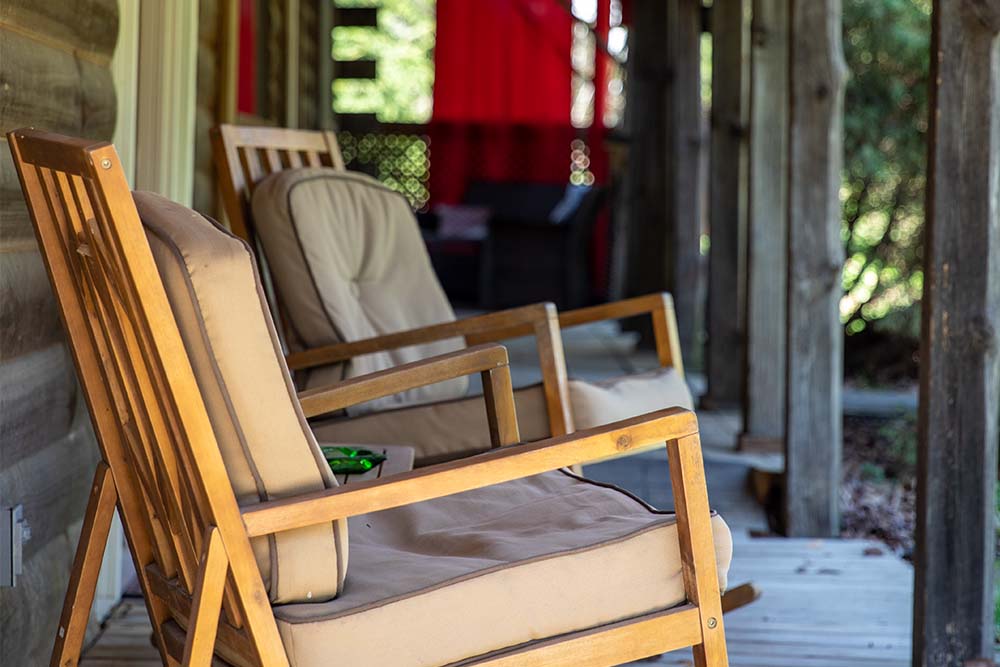 rocking chairs with tan coushions on wood deck