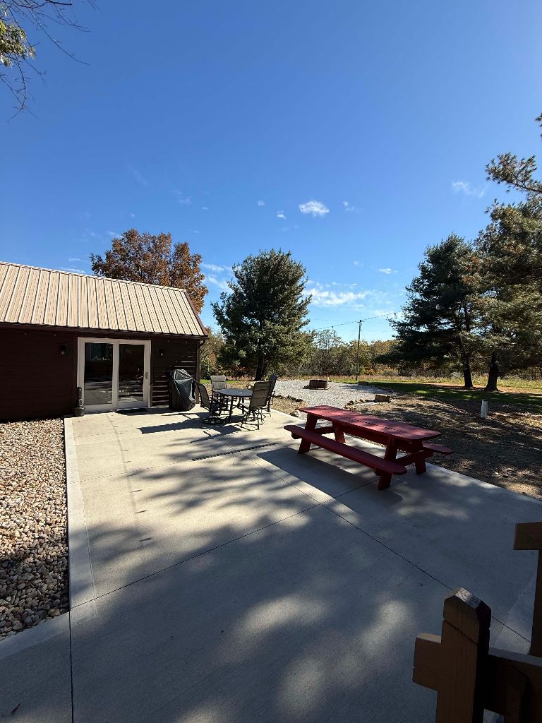 Back patio with picnic table, dining set and grill