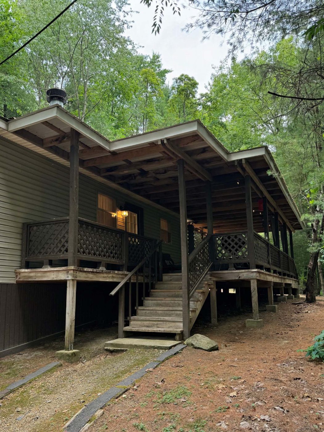 Covered deck and stairs at The Pinewood Cottage, tucked among the trees
