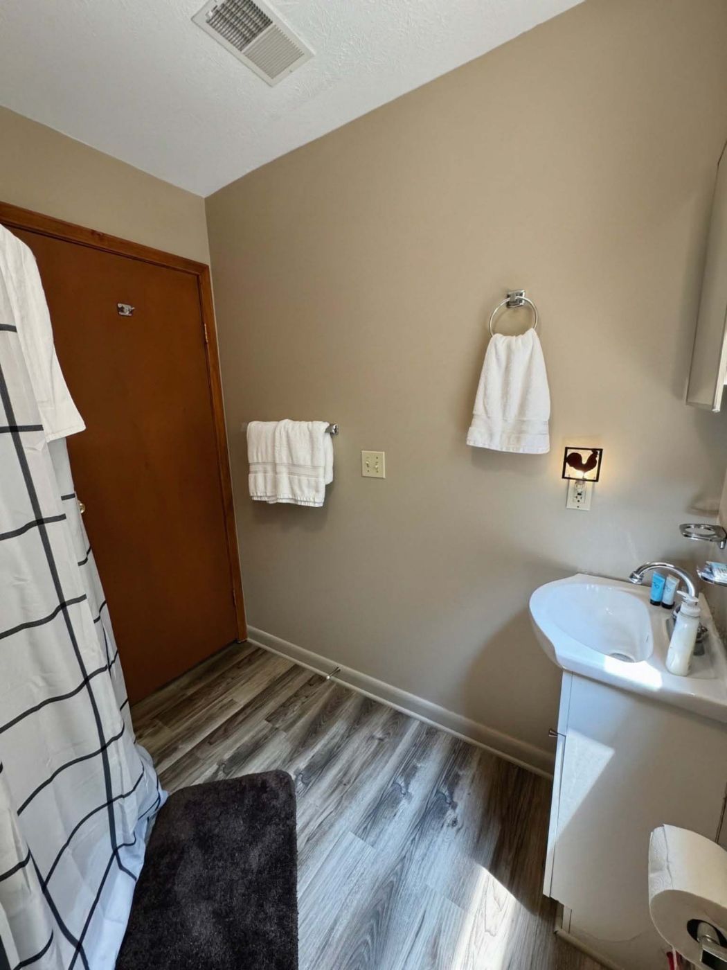 Bathroom with shower, towels and vanity
