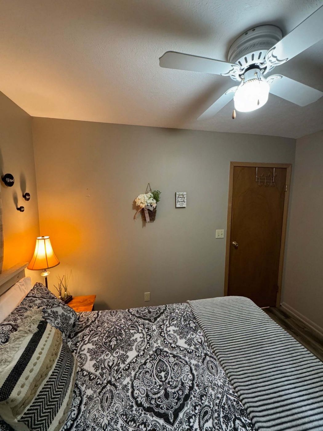 Bedroom with queen-sized bed and ceiling fan