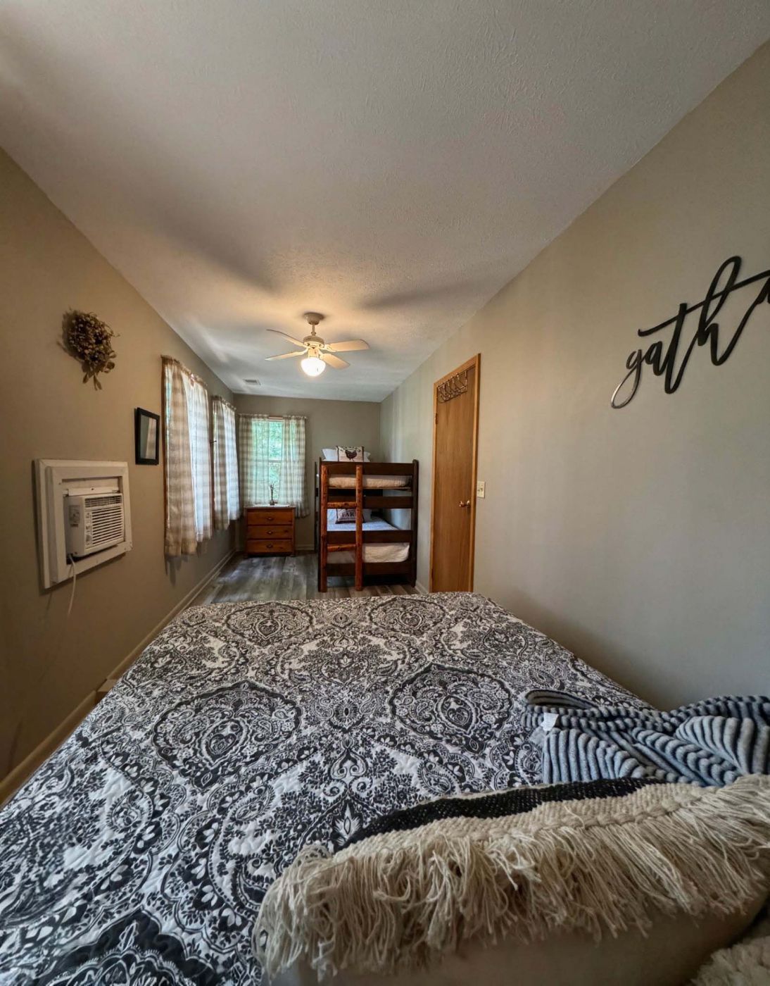Second bedroom with queen-sized bed and a set of bunk beds