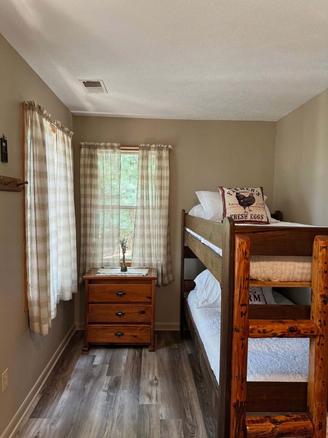 Bunk beds beside the window in the second bedroom