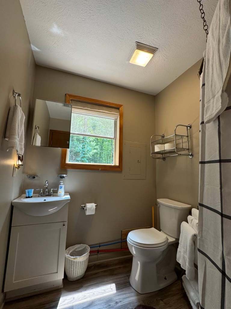 Bathroom with single sink, mirror and window