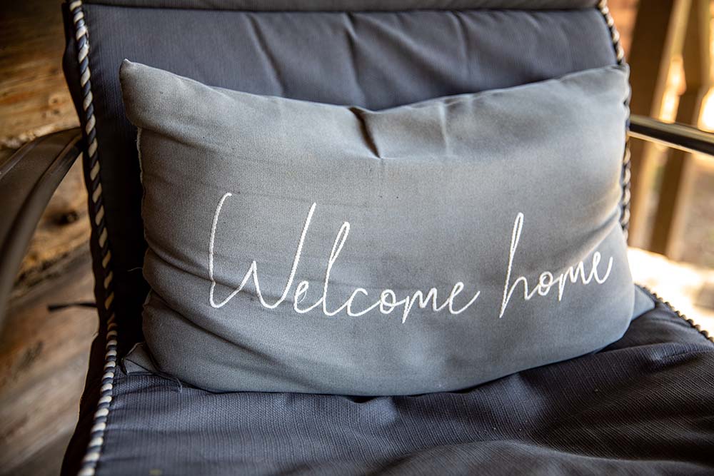 Welcome pillow on chair
